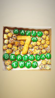 A custom 'Happy 7th Birthday Emma' donut box